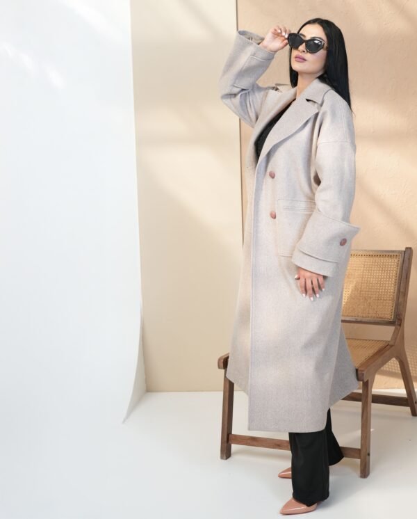 grace-beige-mantle-front-view – A woman modeling the beige mantle coat with oversized sleeves