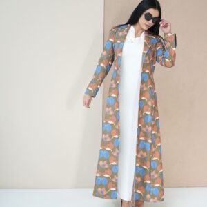 blossom-bloom-mantle-front-view – A woman modeling a vibrant floral-patterned mantle coat.