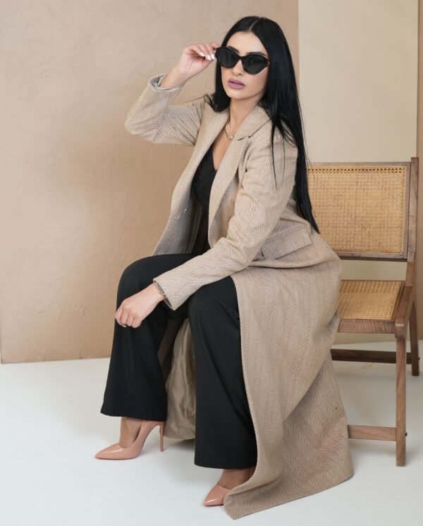 classic-sand-mantle-front-view – Woman modeling a sand beige mantle coat with double-breasted buttons.