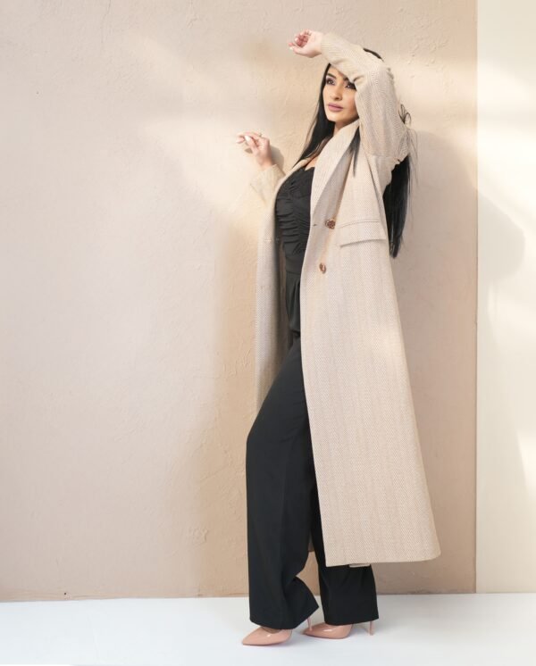 classic-sand-mantle-front-view – Woman modeling a sand beige mantle coat with double-breasted buttons.