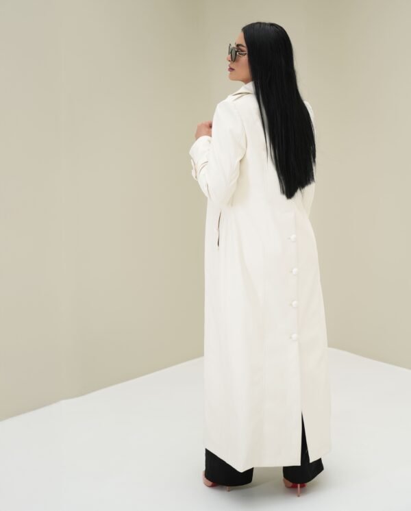 ivory-elegance-mantle-front-view – Woman modeling an ivory mantle coat with a structured silhouette