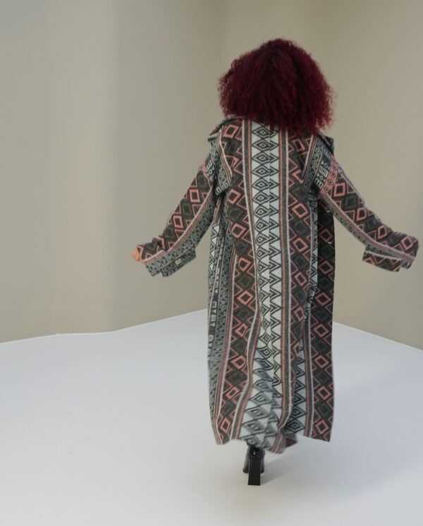 ethnic-geometric-mantle-full-view – Woman modeling a geometric-patterned mantle coat with relaxed styling.
