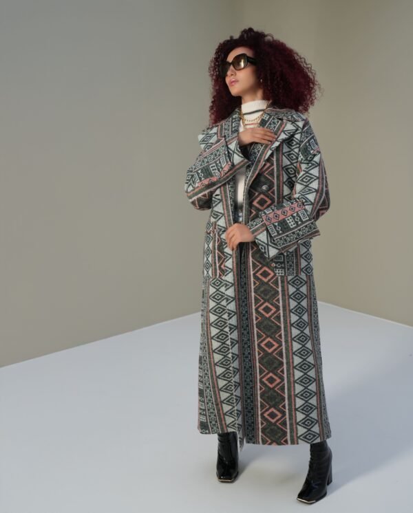 ethnic-geometric-mantle-full-view – Woman modeling a geometric-patterned mantle coat with relaxed styling.