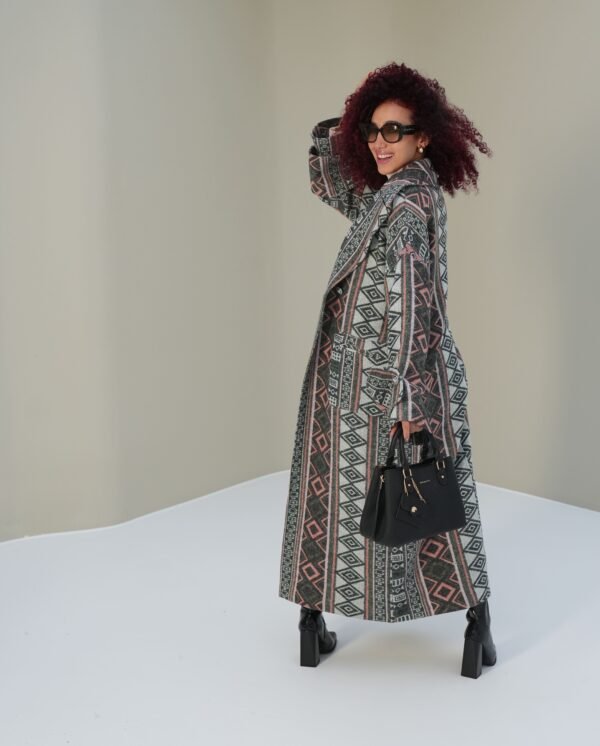 ethnic-geometric-mantle-full-view – Woman modeling a geometric-patterned mantle coat with relaxed styling.